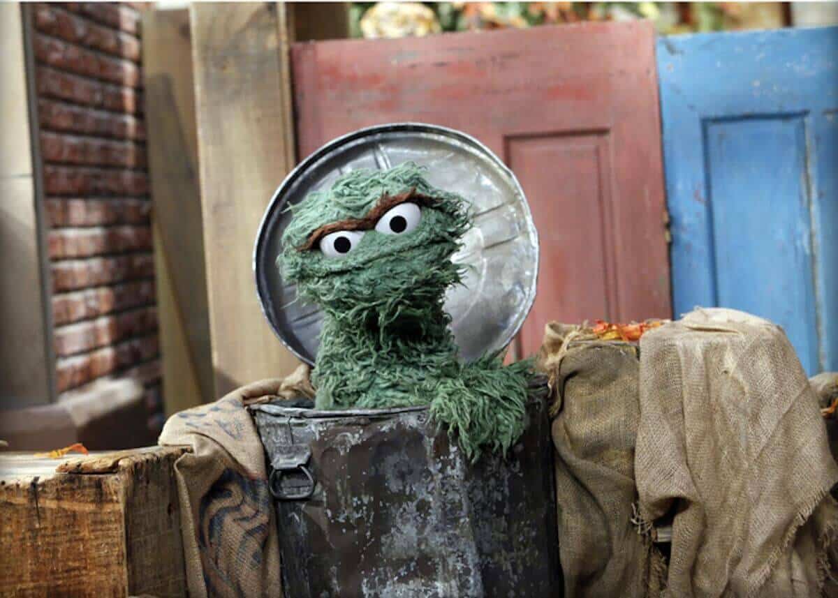 Oscar the Grouch green character from Sesame Street living in a trash can and known for saying Scram